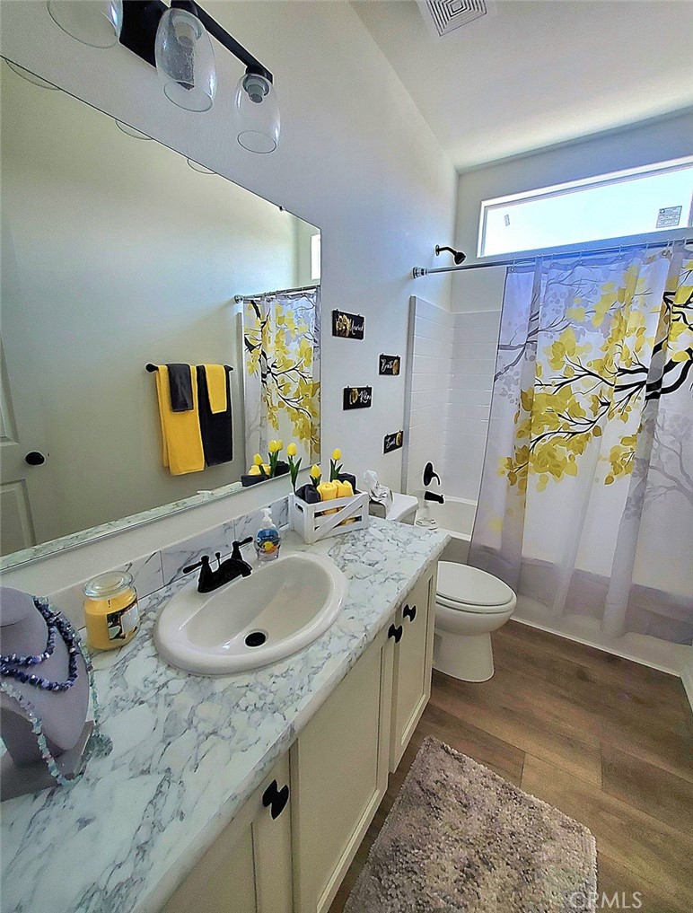 21621 Sandia Road, Unit 138 Apple Valley, CA 92308 - Photo 19 of 38 a bathroom with a sink toilet and shower