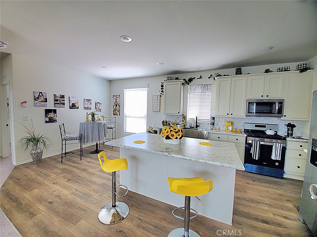 21621 Sandia Road, Unit 138 Apple Valley, CA 92308 - Photo 2 of 38 a living room with stainless steel appliances furniture a rug and a view of kitchen