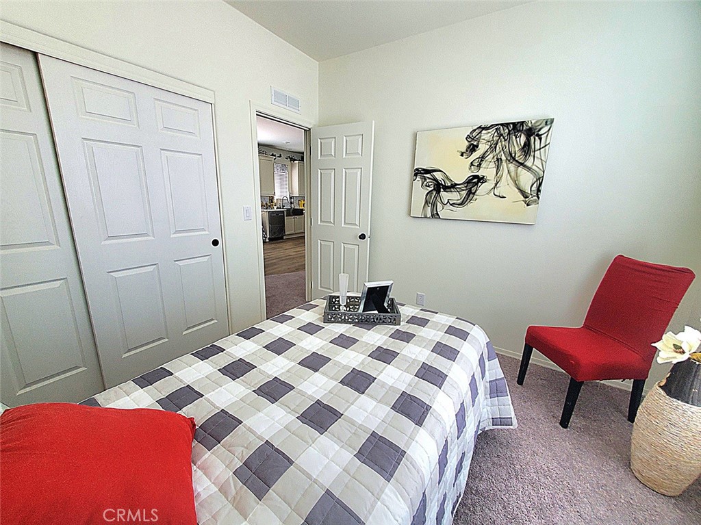 21621 Sandia Road, Unit 138 Apple Valley, CA 92308 - Photo 21 of 38 a bedroom with a bed and furniture