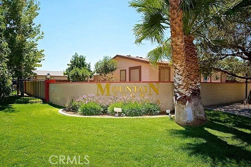21621 Sandia Road, Unit 138 Apple Valley, CA 92308 - Photo 27 of 38 a view of a garden with plants and large trees