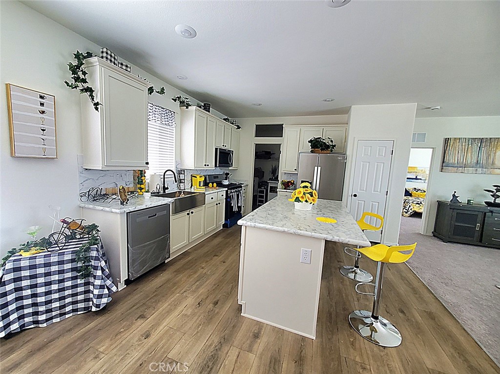 21621 Sandia Road, Unit 138 Apple Valley, CA 92308 - Photo 10 of 38 a kitchen with a sink appliances and wooden floor