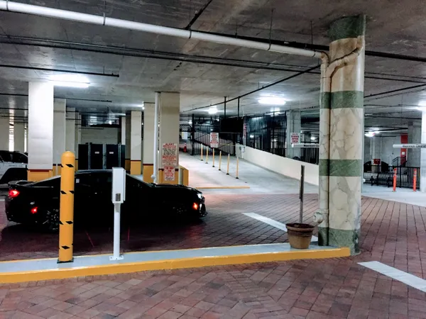 a living room with furniture and a refrigerator