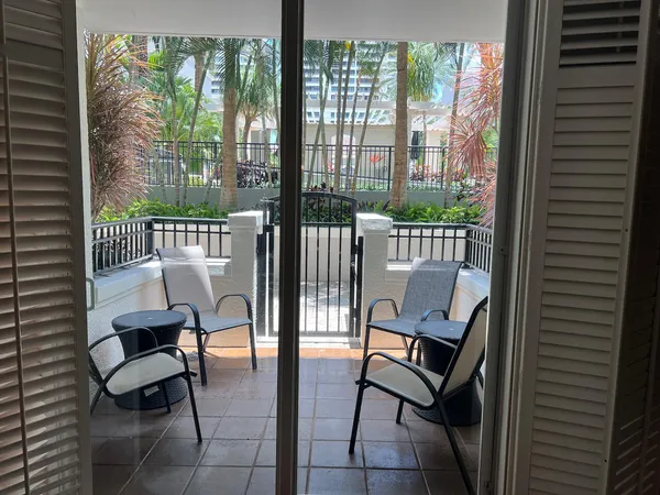 a bedroom with a bed and a potted plant on the dresser