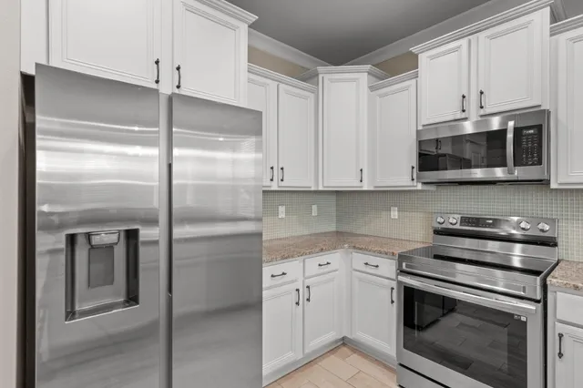 a view of a dining room with furniture a chandelier and wooden floor