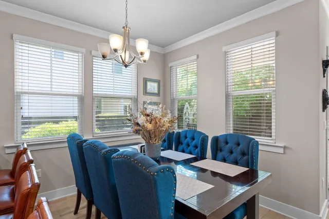 a kitchen with granite countertop a sink and a flat screen tv