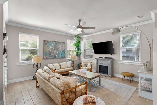 a living room with furniture a fireplace and a flat screen tv