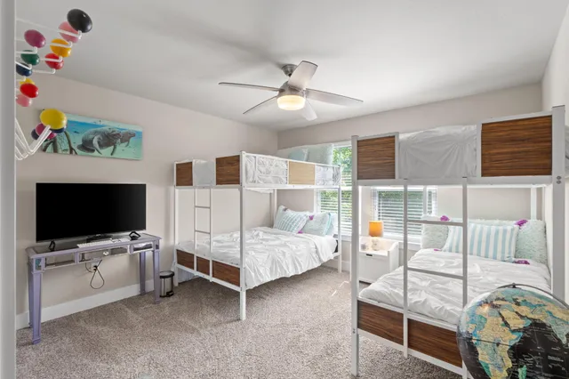 a bathroom with a granite countertop sink mirror vanity and toilet