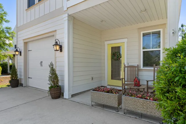front view of a house with a potted plant and a yard