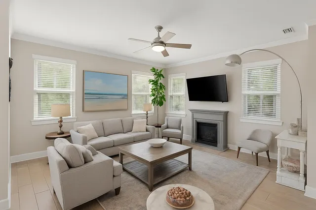 a living room with furniture a fireplace and a flat screen tv