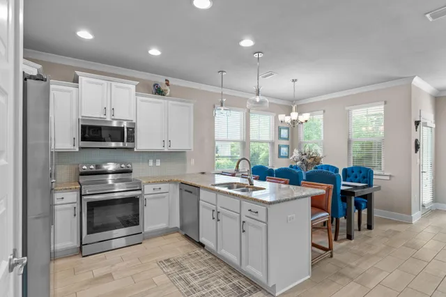 a kitchen with stainless steel appliances white cabinets and a stove