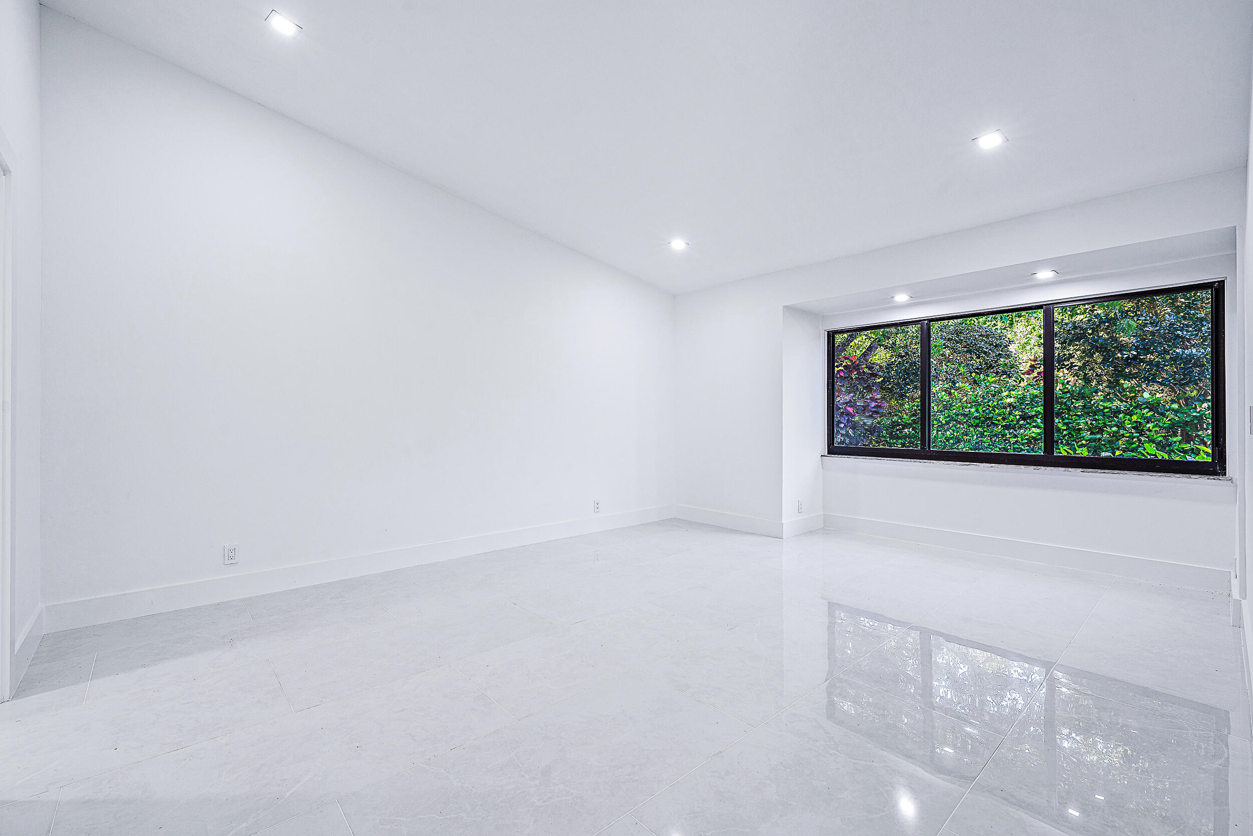 Undisclosed Address Jupiter, FL 33477 - Photo 16 of 30 a view of an empty room with a window