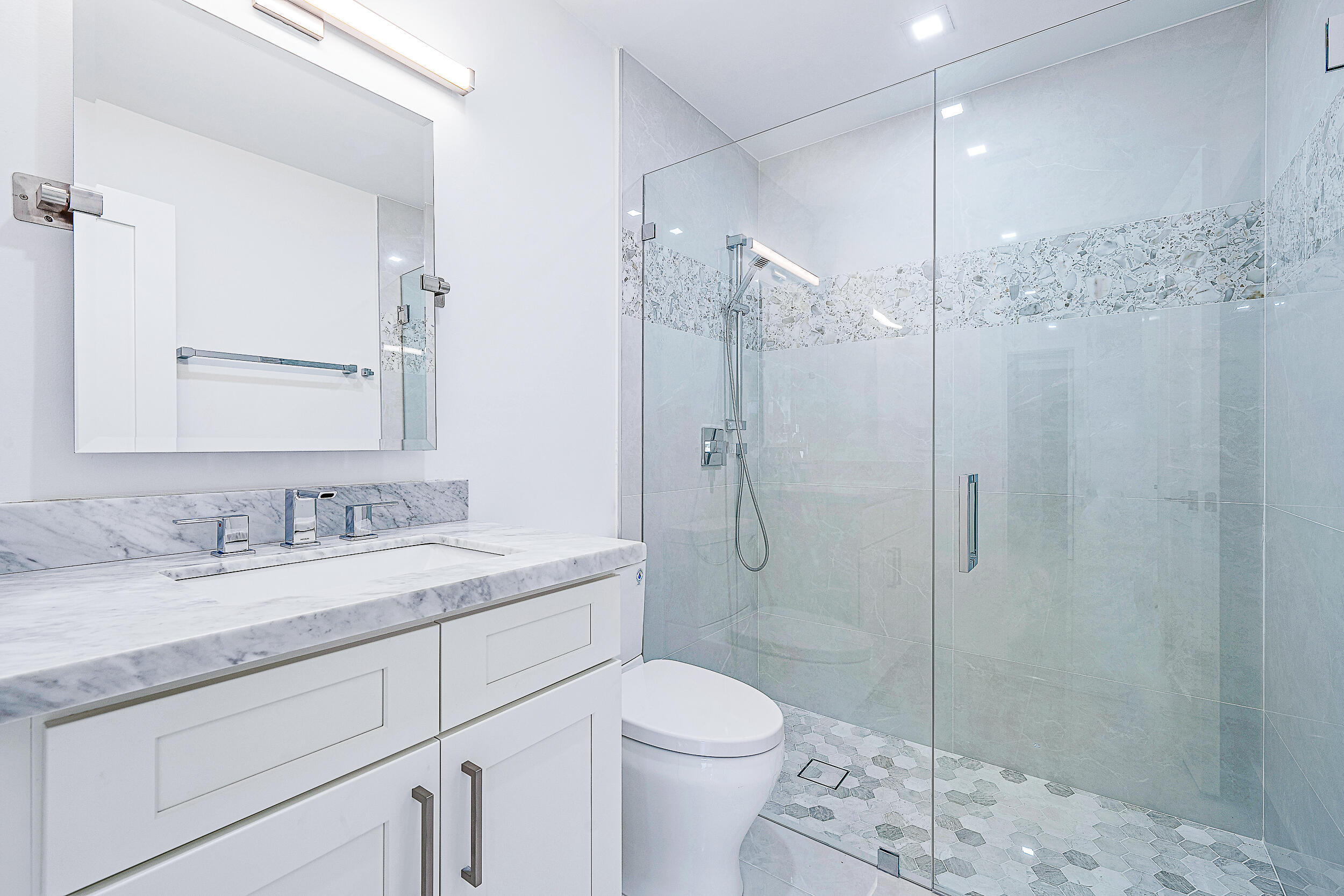 Undisclosed Address Jupiter, FL 33477 - Photo 20 of 30 a bathroom with a sink a toilet and shower