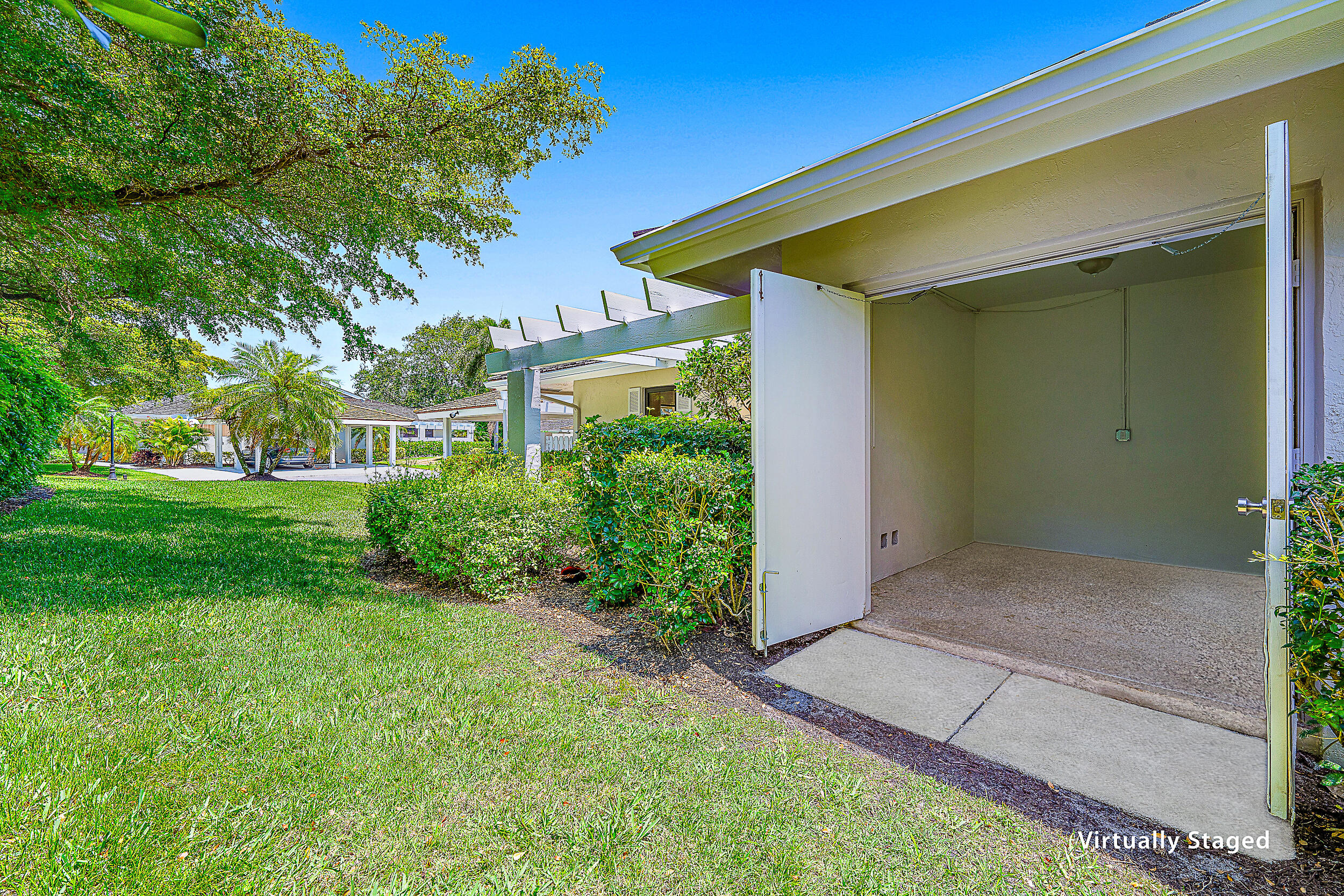 Undisclosed Address Jupiter, FL 33477 - Photo 22 of 30 a front view of a house with a yard