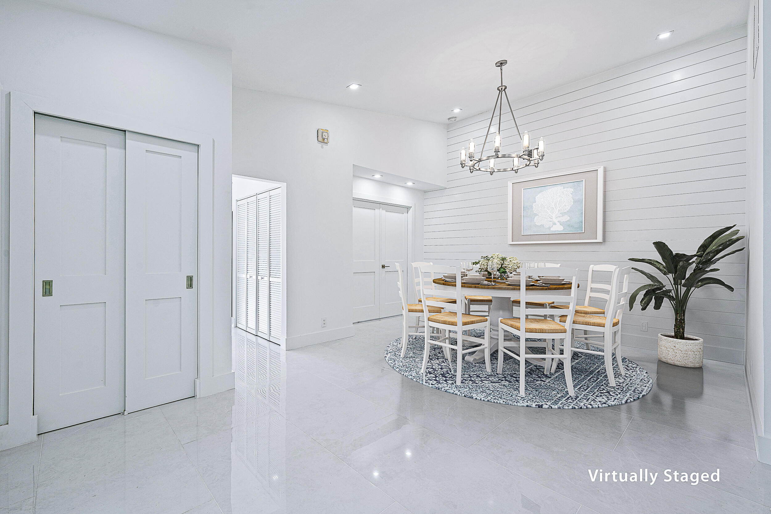 Undisclosed Address Jupiter, FL 33477 - Photo 10 of 30 a view of a dining room with furniture and chandelier