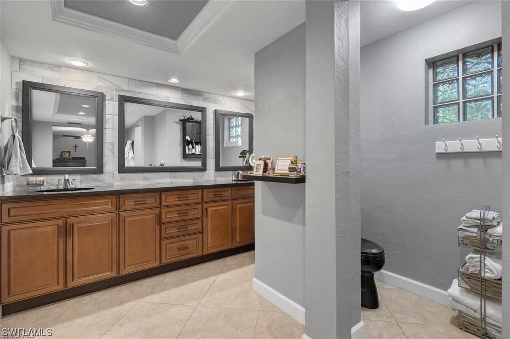 13951 River Road Fort Myers, FL 33905 - Photo 17 of 34 a spacious bathroom with a granite countertop sink and a mirror