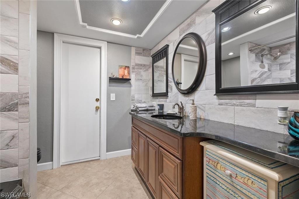 13951 River Road Fort Myers, FL 33905 - Photo 19 of 34 a bathroom with a sink a mirror and a toilet