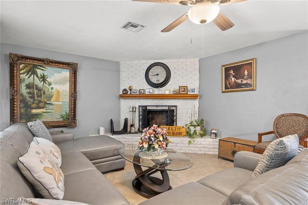13951 River Road Fort Myers, FL 33905 - Photo 3 of 34 a living room with furniture and a fireplace