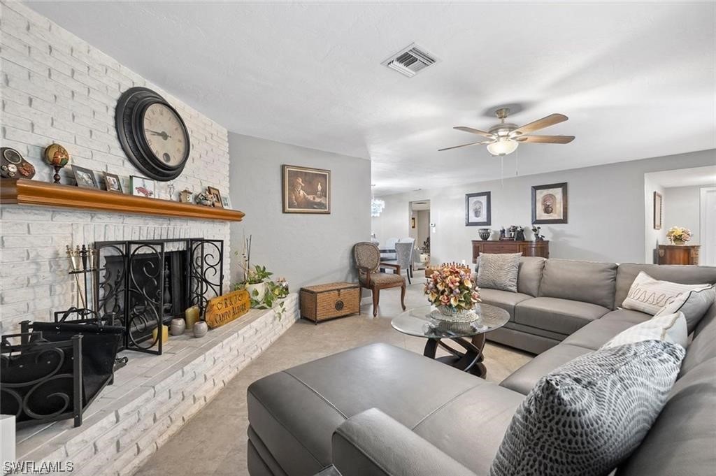 13951 River Road Fort Myers, FL 33905 - Photo 4 of 34 a living room with furniture a clock and a fireplace