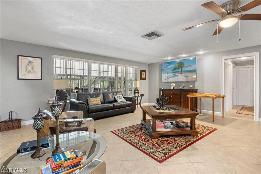 13951 River Road Fort Myers, FL 33905 - Photo 5 of 34 a living room with furniture and a rug