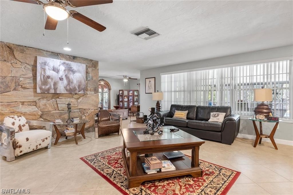 13951 River Road Fort Myers, FL 33905 - Photo 6 of 34 a living room with furniture and a large window