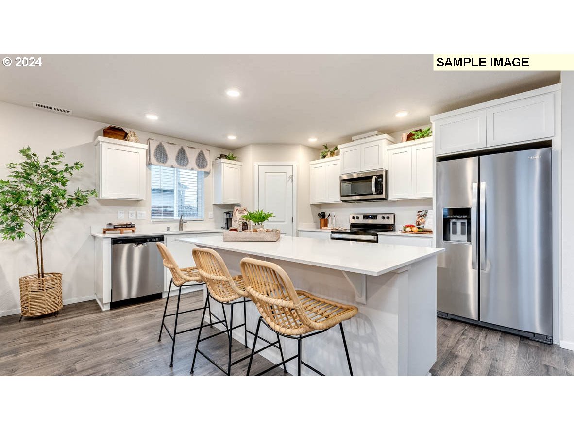 812 Northwest 175th Street Ridgefield, WA 98642 - Photo 8 of 25 a kitchen with a table and chairs in it