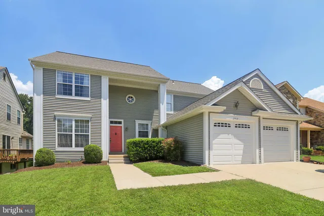 a view of a house with a yard and potted plants