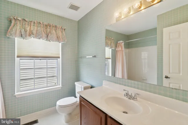 a front view of a house with a garden and plants