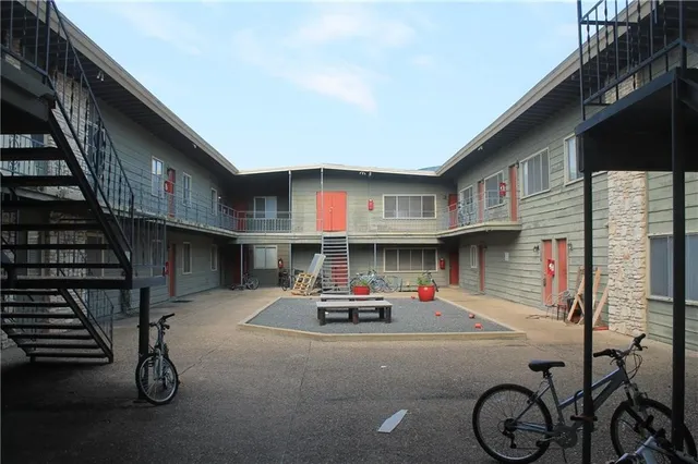 a car parked beside a road next to a building