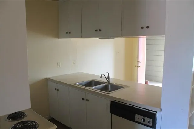 a kitchen with a sink and cabinets