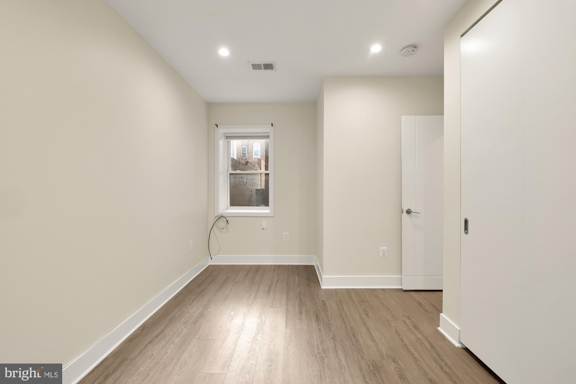 58 T Street Northwest, Unit 1 Washington, DC 20001 - Photo 13 of 27 wooden floor in an empty room with a window