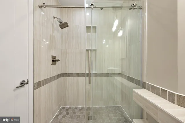 a bathroom with a glass shower door