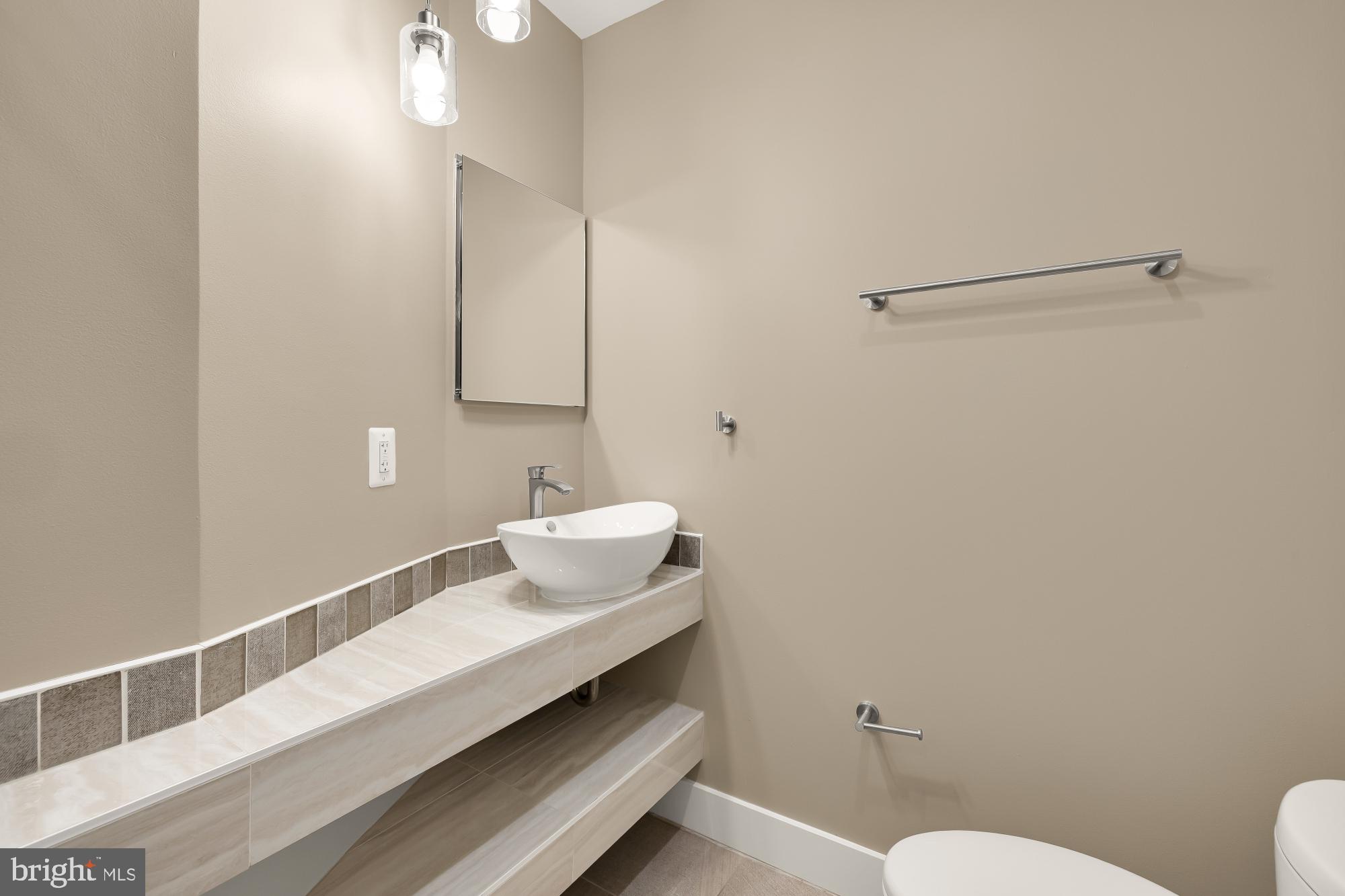 58 T Street Northwest, Unit 1 Washington, DC 20001 - Photo 15 of 27 a bathroom with a sink mirror vanity and toilet