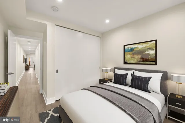 a bedroom with a bed and a painting on the wall