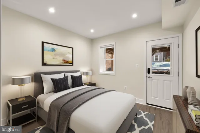 a bedroom with a bed and a painting