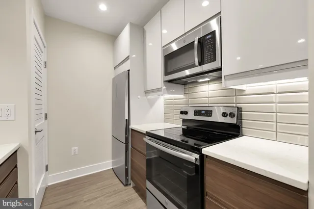 a kitchen with stainless steel appliances and cabinets