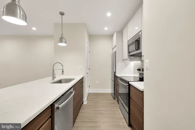 a kitchen with sink cabinets and stove