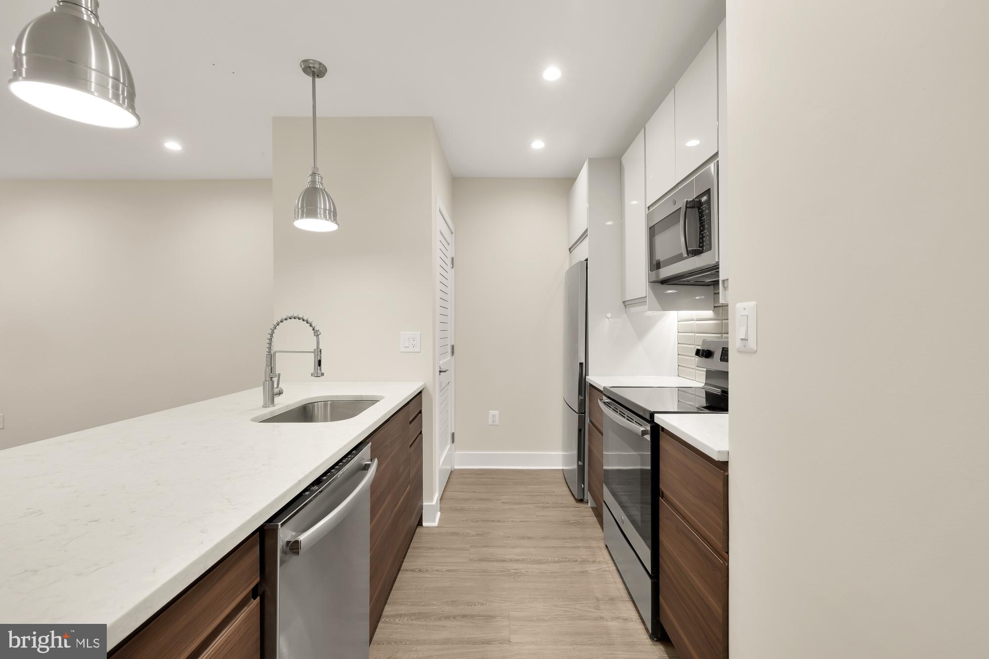 58 T Street Northwest, Unit 1 Washington, DC 20001 - Photo 9 of 27 a kitchen with sink cabinets and stove