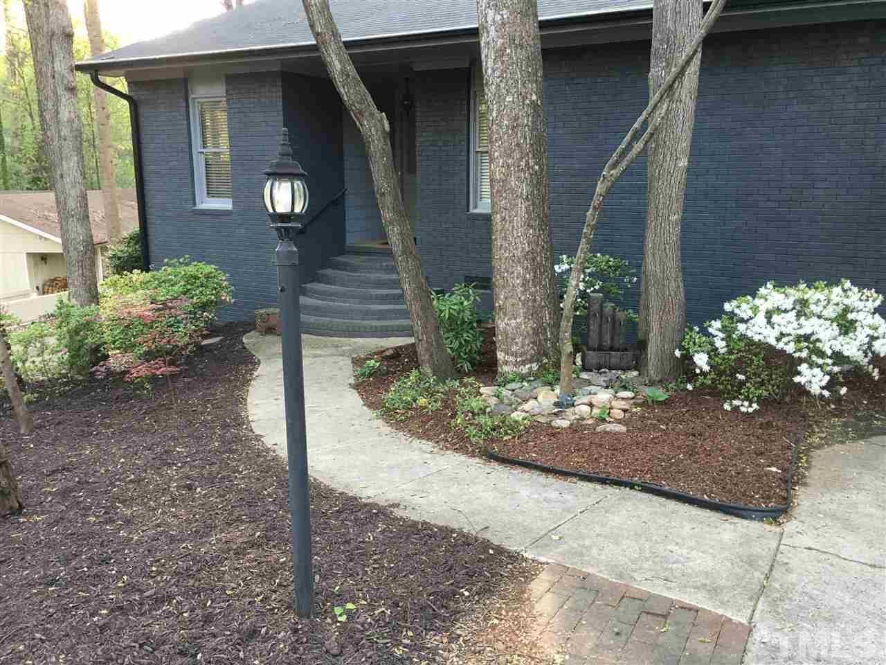 2955 Rue Sans Famille Raleigh, NC 27607 - Photo 2 of 21 a front view of a house with garden