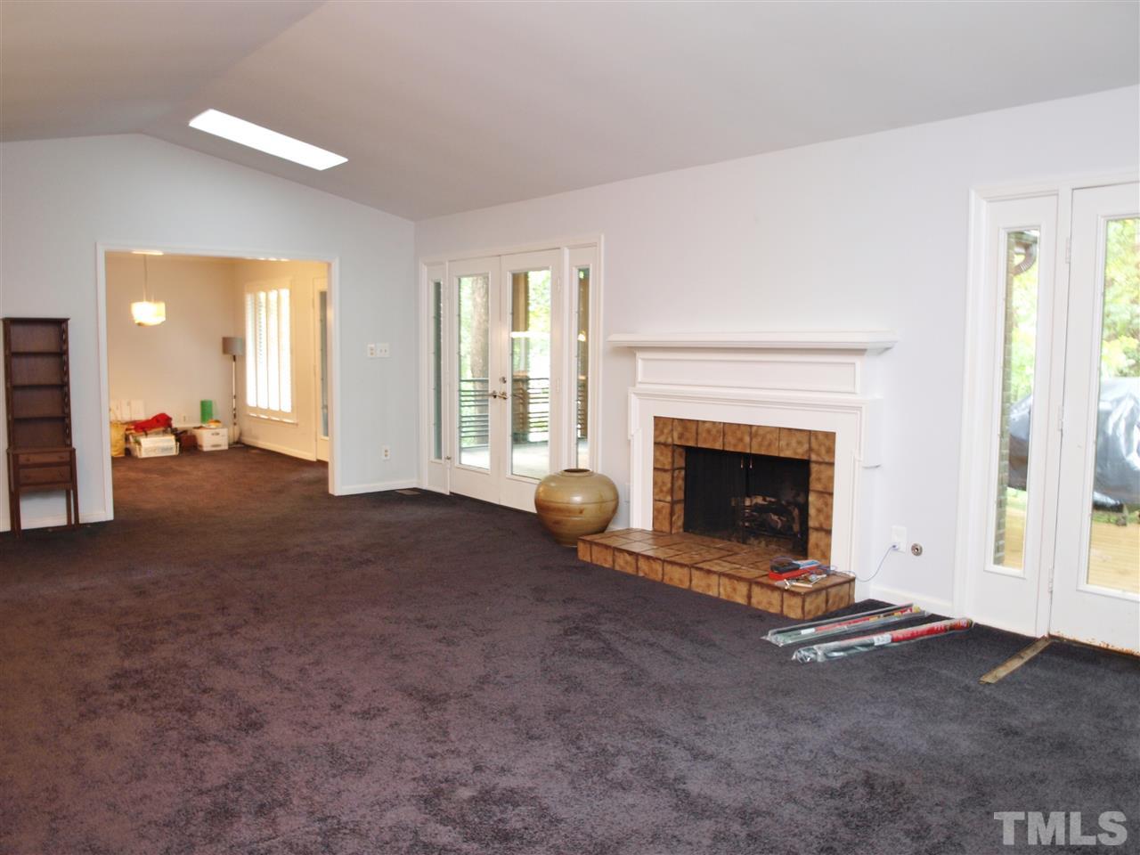 2955 Rue Sans Famille Raleigh, NC 27607 - Photo 4 of 21 a view of a livingroom with a fireplace and window
