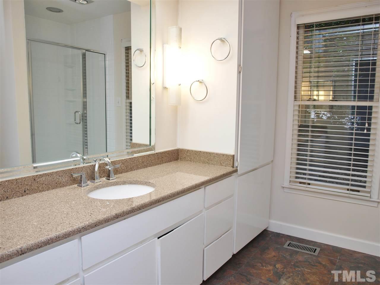 2955 Rue Sans Famille Raleigh, NC 27607 - Photo 10 of 21 a bathroom with a granite countertop sink and a mirror