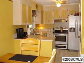 12600 Newstead Road Huntersville, NC 28078 - Photo 3 of 8 a kitchen with a refrigerator and a stove