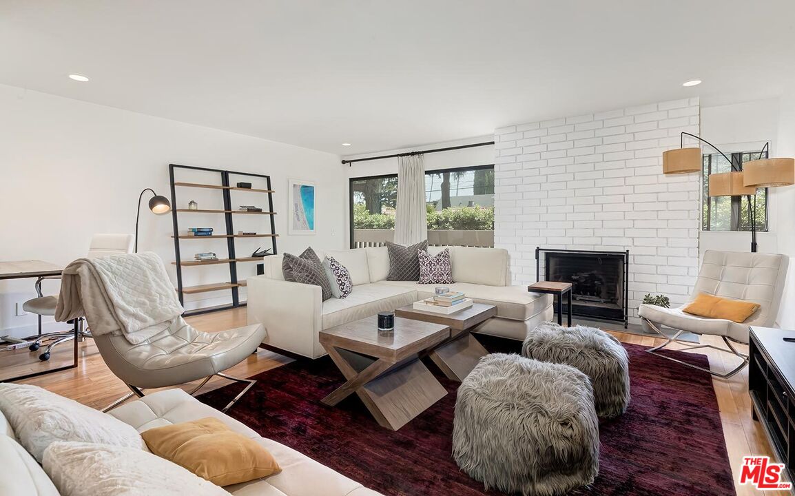 858 12th Street, Unit 4 Santa Monica, CA 90403 - Photo 1 of 18 a living room with furniture fireplace and a window