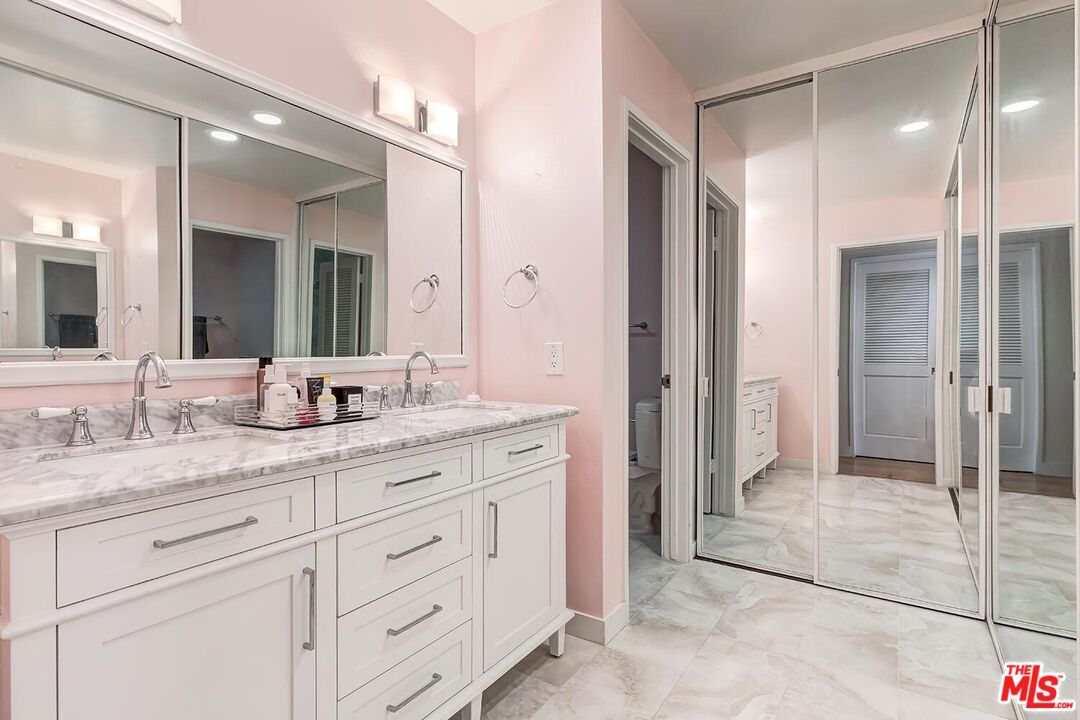 858 12th Street, Unit 4 Santa Monica, CA 90403 - Photo 13 of 18 a spacious bathroom with a granite countertop sink mirror and shower