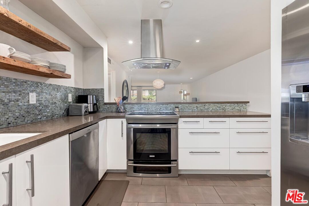 858 12th Street, Unit 4 Santa Monica, CA 90403 - Photo 4 of 18 a kitchen with a stove oven and cabinets