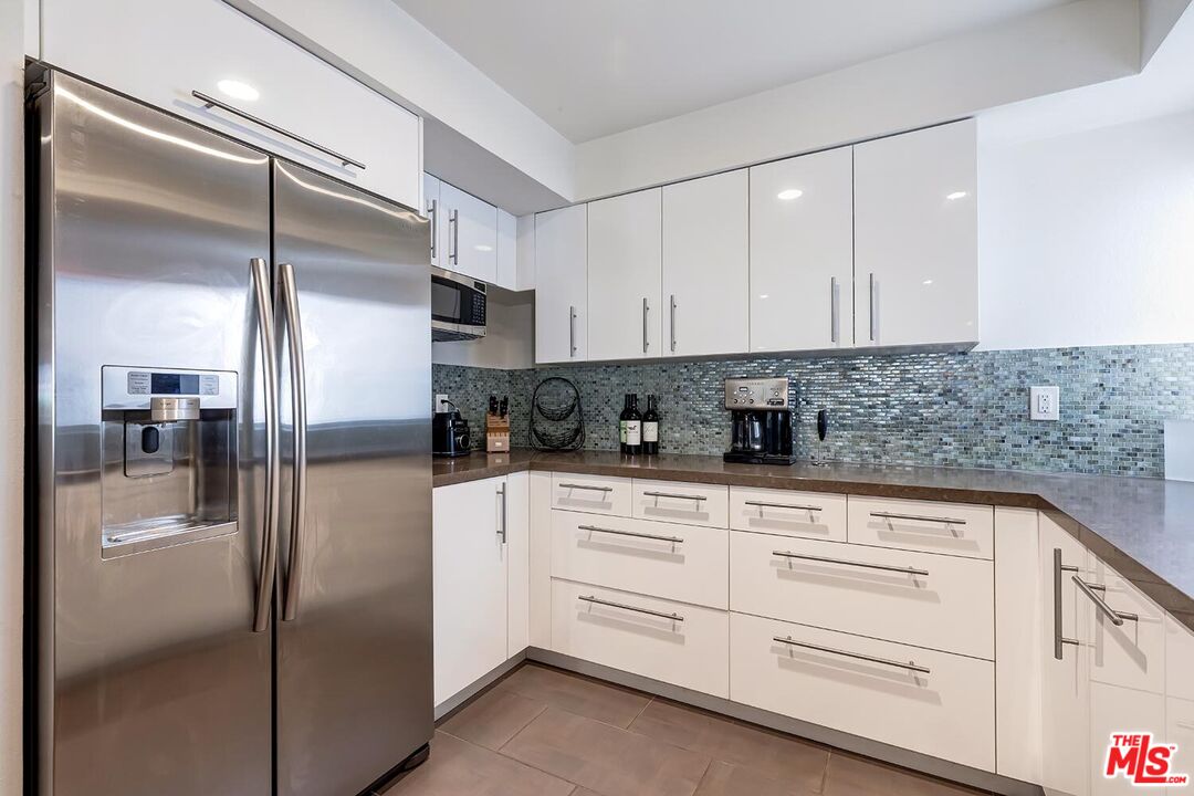 858 12th Street, Unit 4 Santa Monica, CA 90403 - Photo 6 of 18 a kitchen with cabinets stainless steel appliances and a counter top space