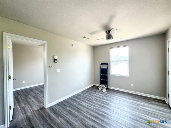 a view of a room with wooden floor and a window