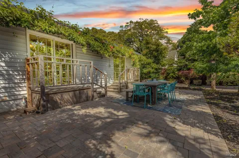 a view of a porch with chairs and potted plants