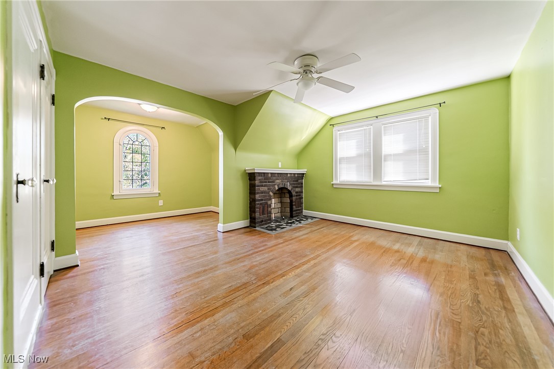 6711 Forest Avenue Parma, OH 44129 - Photo 16 of 33 Bonus room featuring light wood finished floors, a ceiling fan, and arched walkways
