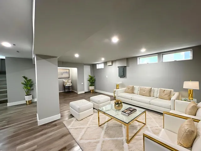 a living room with furniture and a wooden floor