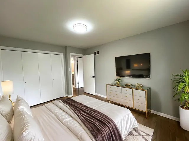 a bedroom with a bed and a flat screen tv